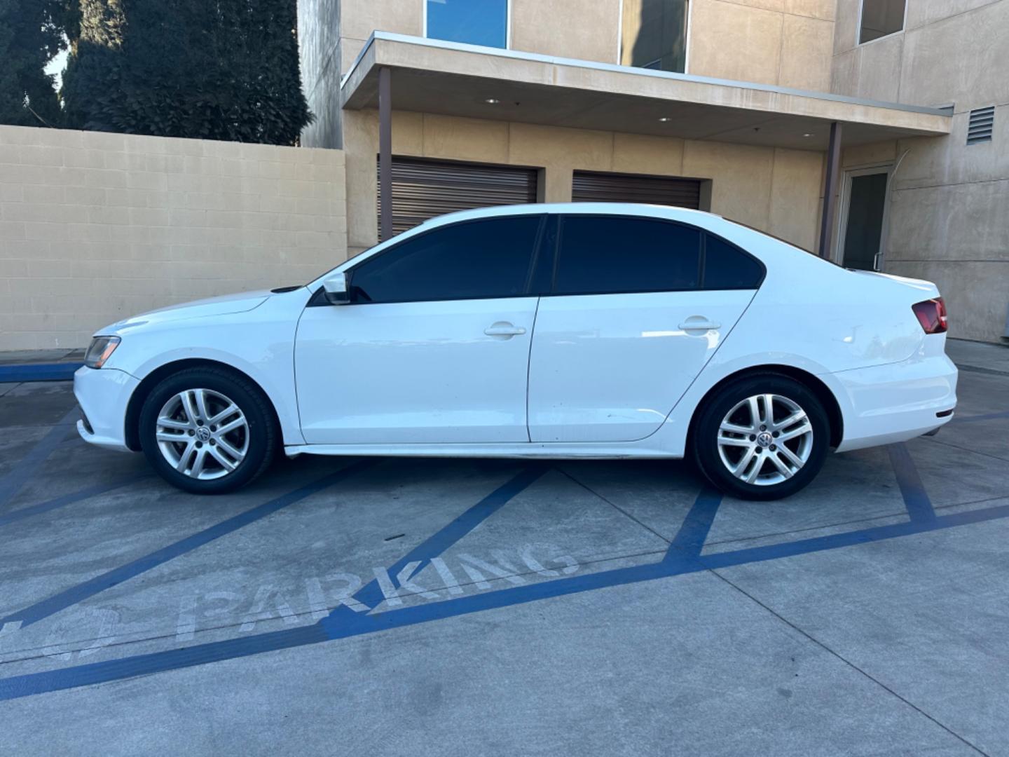 2018 WHITE /BLACK Volkswagen Jetta 1.4T S 6A (3VW2B7AJ9JM) with an 1.4L L4 DOHC 20V engine, 6A transmission, located at 30 S. Berkeley Avenue, Pasadena, CA, 91107, (626) 248-7567, 34.145447, -118.109398 - Crown City Motors is a used “Buy Here Pay Here” car dealer in Pasadena CA. “Buy Here Pay Here” financing, means that when you purchase your vehicle from our dealership, that you make the payments to the dealership as well. We do not need the banks approval to get you approved for a used auto - Photo#1